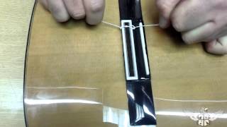 How to restring a nylon string classical guitar [upl. by Ansell514]