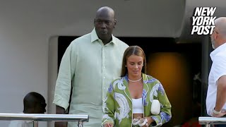 Michael Jordan holds hands with wife Yvette Prieto after leaving his 115 million yacht in Barcelona [upl. by Aitra]