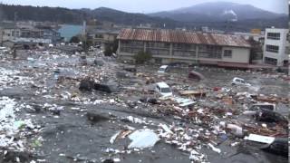 Tsunami in Kesennuma city ascending the Okawa river [upl. by Aciemaj]