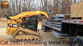 Cat 299D XHP Unloading the Framing for a 80x100 Metal Building [upl. by Zuzana566]