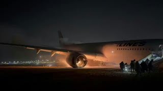 Passengers flee Japan Airlines plane on fire at Toyko airport  AFP [upl. by Noskcaj]